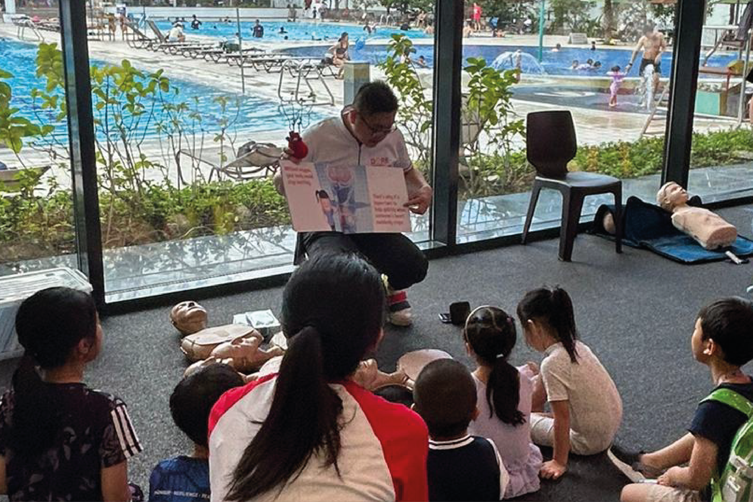 Photo of a facilitator reading the DARE storybook to children.